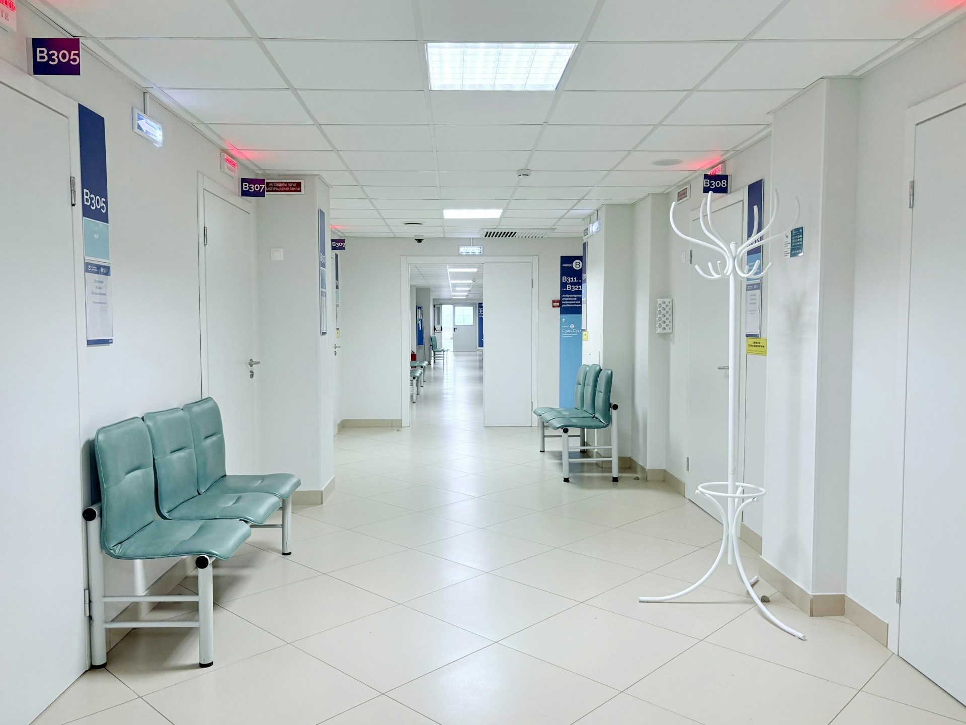 A real hospital corridor with seating and consultation rooms